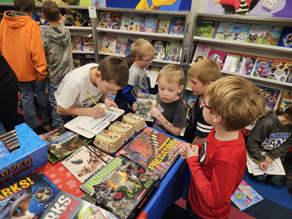 students looking at books