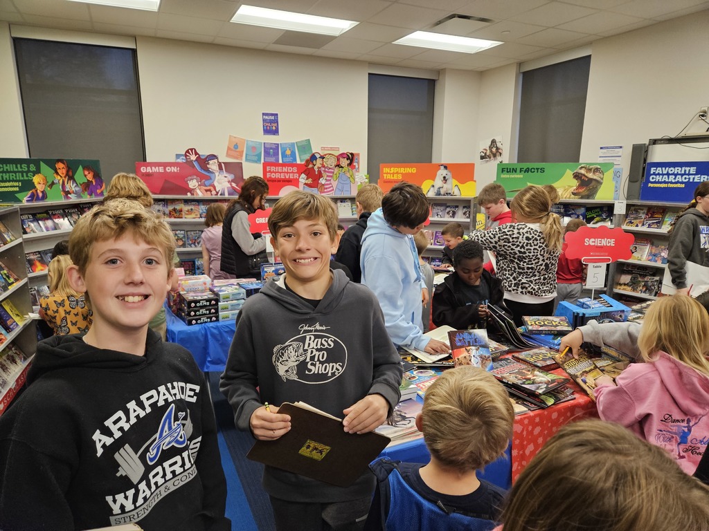students looking at books