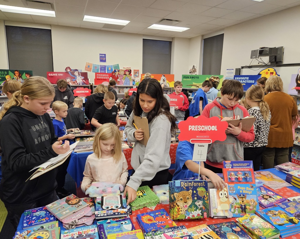 students looking at books